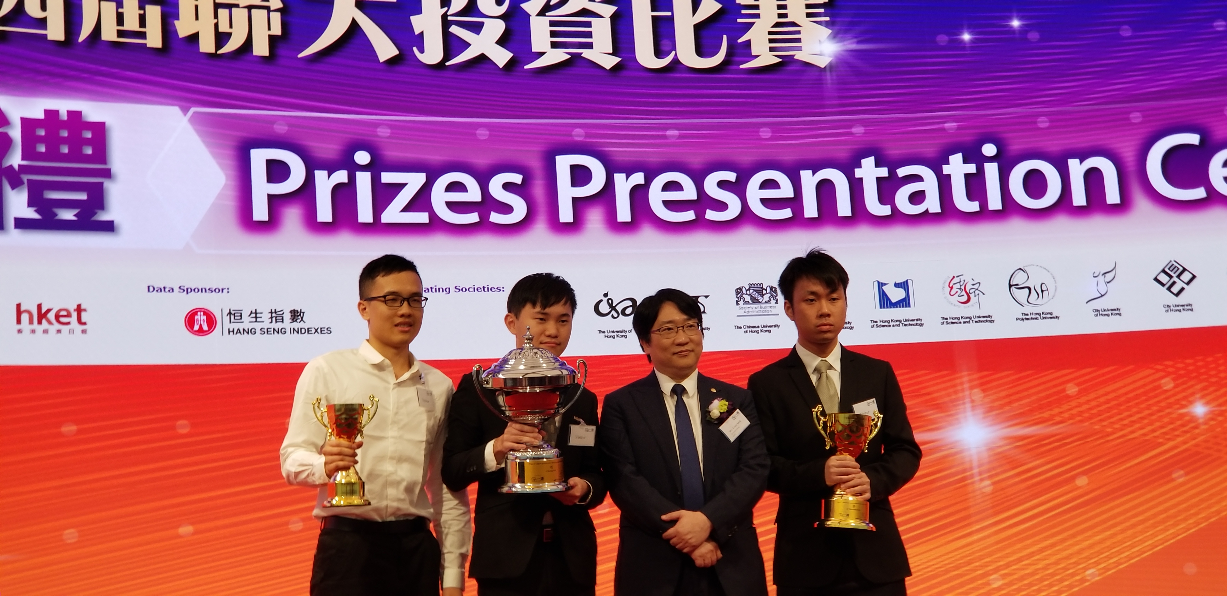 Chan King Wa, Kingson, alumnus of Associate Degree (Financial Management) (2nd from the left) and Siu Tat Ming, John, Associate Degree Year one (Financial Technology (far left) won the championship and 2nd runner-up respectively in the 4th Joint University Investment Game